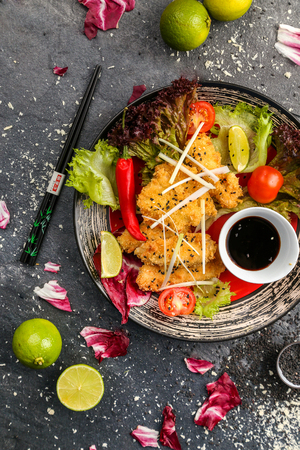 Japanese, chicken in sweet and sour sauce with vegetables on a white plateのeditorial素材