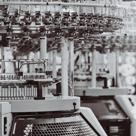 Textile factory. Factory on manufacture of threads. Rows of automated machines for yarn manufacturing. Modern Textile Plant.の写真素材