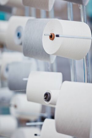 Textile Manufacturing. Knitted fabric. Textile factory in spinning production line and a rotating machinery and equipment production company.の写真素材
