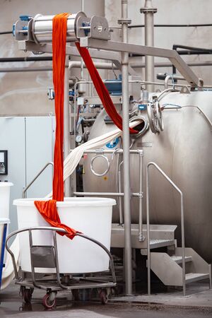Textile Manufacturing. Knitted fabric. Textile factory in spinning production line and a rotating...