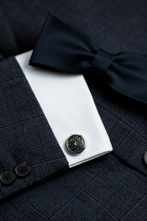 Luxury bow tie close up with vintage suit and cufflink.