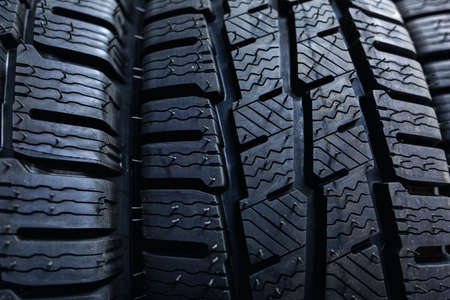 Tires close up. Black studdable winter tire profile. Car tires in a row.の写真素材