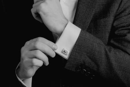 Man in suit hold his white shirt with cuff links.の写真素材