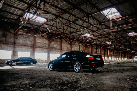 Rivne, Ukraine - September 26, 2019: BMW 5 series e39 and E60 at the old industrial building.
