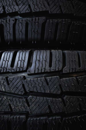 Tires close up. Black studdable winter tire profile. Car tires in a row.の写真素材