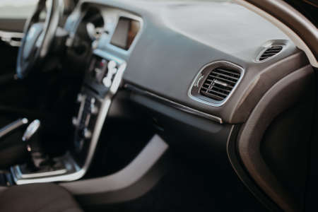 Air vent grill in modern car interior.