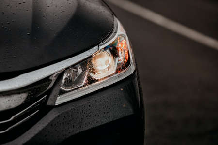 Detail on one of the headlights modern car at night.の写真素材