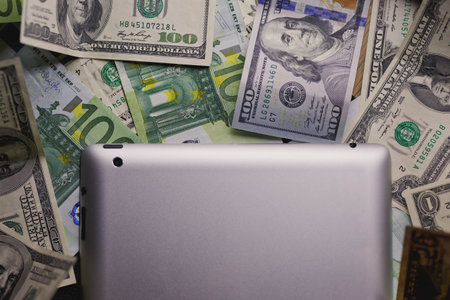 Laptop on the background of the dollar banknotes. Business conceptの写真素材
