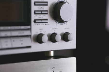 Vintage audio stereo rack with cassette tape deck receiver and speaker, angled viewの写真素材