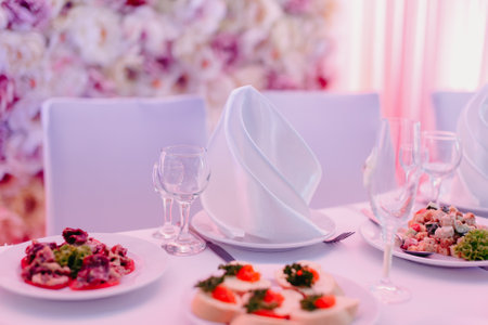 Table set for a banquet or wedding reception with flowers.の写真素材