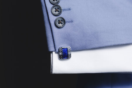 Luxury blue Cufflinks on the blue suit closeup.の写真素材