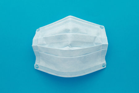 Medical mask, Medical protective masks on blue background. Disposable surgical face mask cover the mouth and nose. Healthcare and medical concept.の写真素材
