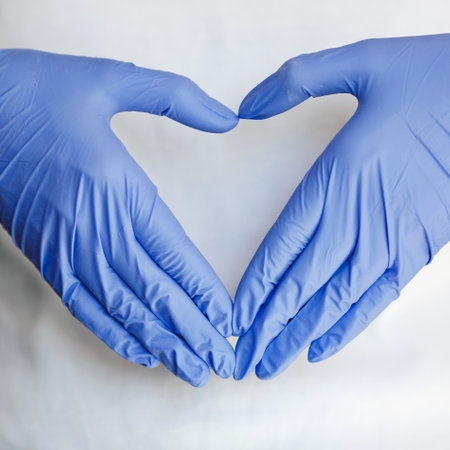 Gloved hands make a heart. Hand wears a protective glove for cleaning or tidying. Female hand...