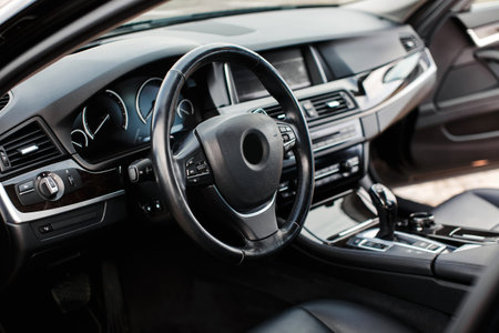 Interior of a luxury modern car. Steering wheel and dashboardの写真素材