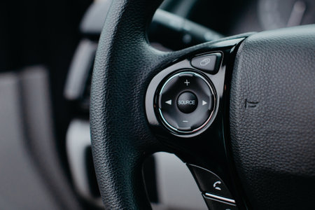 Close up of the steering wheel of a modern car, selective focusの写真素材