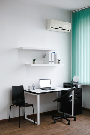 interior of modern office with air conditioner, nobody on tableの写真素材