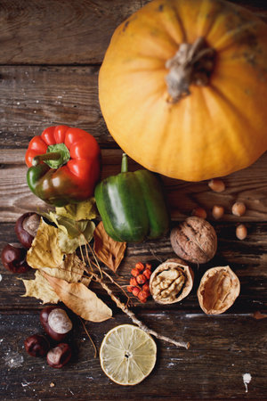 Autumn still life with pumpkins, vegetables and nuts on wooden backgroundの写真素材