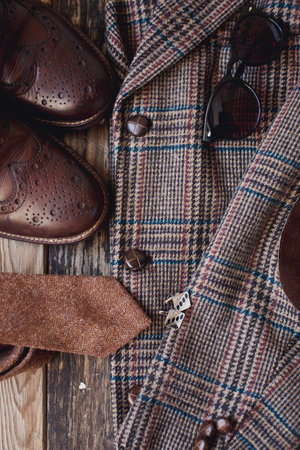 Men's clothing and accessories on a wooden background. Top view.の写真素材