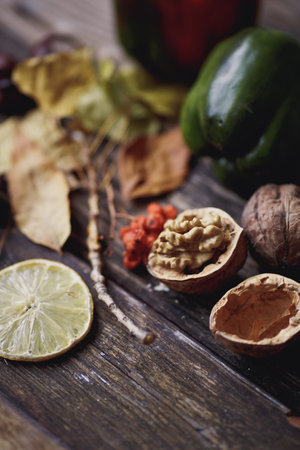 pepper, walnut and lime on a wooden table. selective focusの写真素材