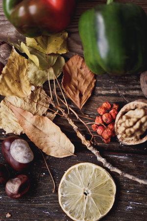 Autumn still life with leaves, nuts and fruits on wooden backgroundの写真素材
