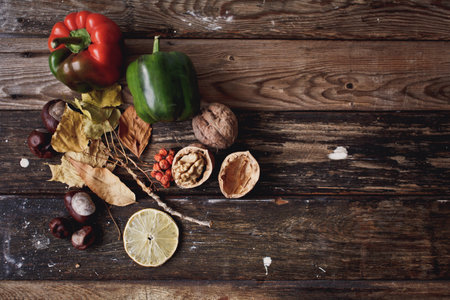 Autumn still life with vegetables, nuts and fruits on wooden backgroundの写真素材