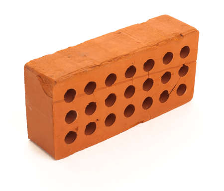 New red perforated ceramic brick isolated on whiteの写真素材
