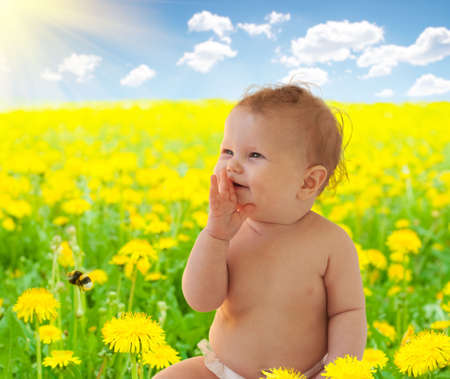 Babygirl sitting among dandelion collageの写真素材