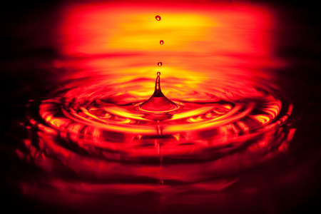 Closeup of water splash in red lightの写真素材