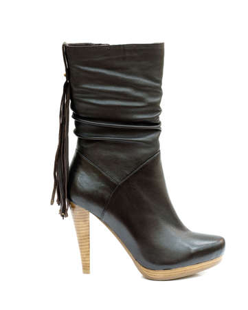 Black female leather boot isolated on whiteの写真素材