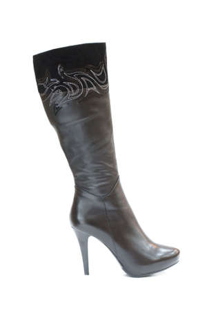 Black female leather boot isolated on whiteの写真素材