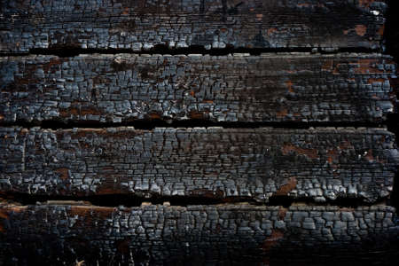 Closeup burned wooden wall after fireの写真素材