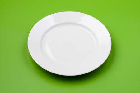White round plate on green backgroundの写真素材