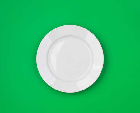 White round plate on green backgroundの写真素材