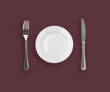 Knife, plate and fork on purple backgroundの写真素材