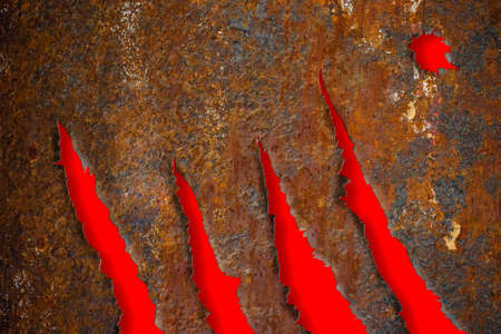 Torn rusty metal texture over red backgroundの写真素材