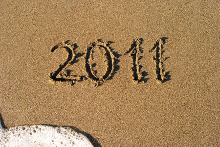 Sand beach and sea foam macro with number 2011の写真素材