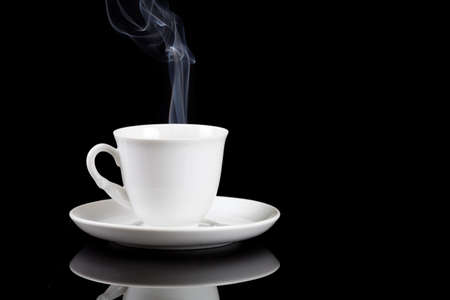 hot coffee cup with reflection on blackの写真素材