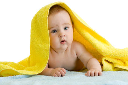 Adorable baby in colorful towelの写真素材