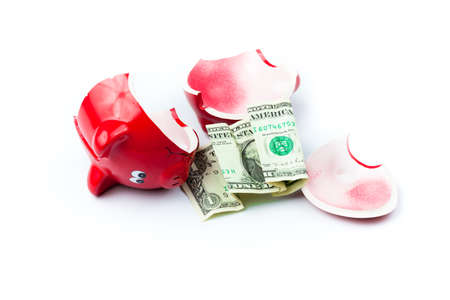 Broken piggy bank or money box with coins isolated on white