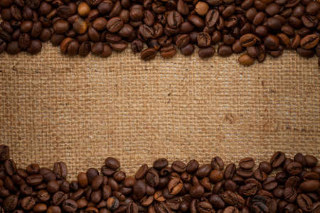 coffee beans on burlap backgroundの写真素材