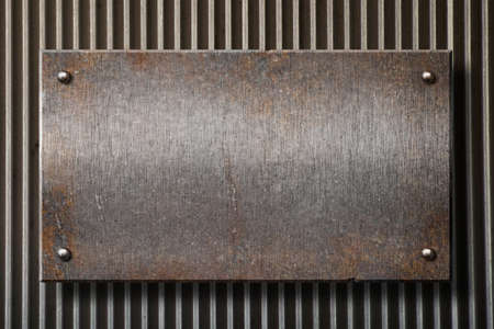 grunge rusty metal plate over grid backgroundの写真素材