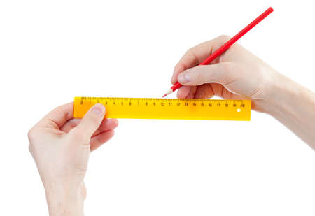yellow centimeters ruler and red pencil in hands isolated on whiteの写真素材