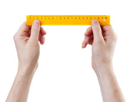 yellow centimeters ruler in hands measure isolated on whiteの写真素材