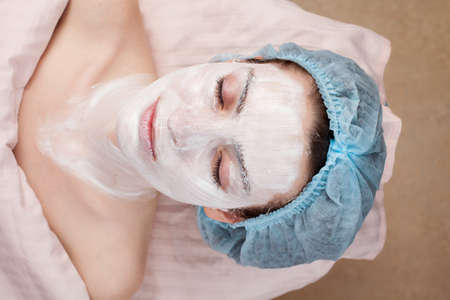 Beautiful woman with clear skin getting beauty treatment of her face at salon   Clear Skin の写真素材