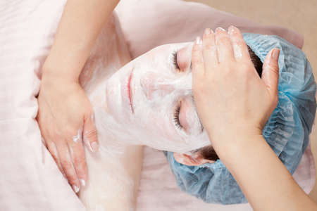 Beautiful woman with clear skin getting beauty treatment of her face at salon   Clear Skin の写真素材