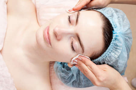 Beautiful woman with clear skin getting beauty treatment of her face at salon   Clear Skin の写真素材