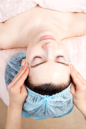 Beautiful woman with clear skin getting beauty treatment of her face at salon   Clear Skin の写真素材