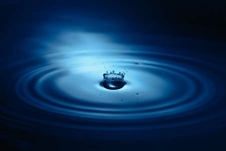 Splash of water drop closeup in blue tonality