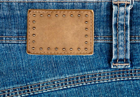 Blank leather jeans label decorated by rivets