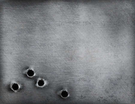 metal background with bullet holesの写真素材